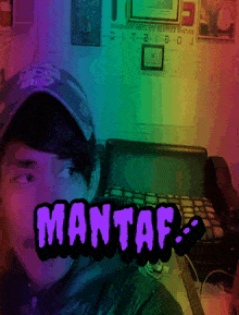 a man taking a selfie with the word mantaf in front of him