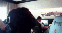 a man wearing headphones is sitting in a room with a secret lab chair