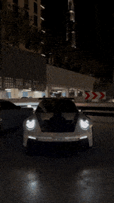 a porsche gt3 r sits in a parking lot
