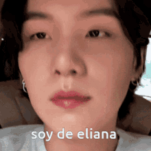 a close up of a person 's face with the words soy de eliana written above it
