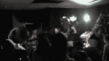 a black and white photo of a group of people playing instruments