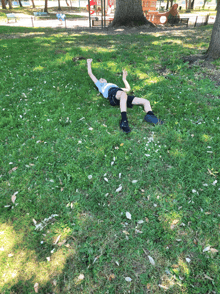 a person laying on their back in the grass