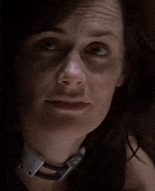 a woman with her eyes closed has a collar around her neck