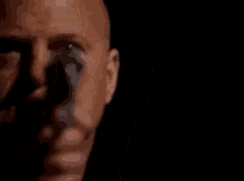 a close up of a man 's face with a gun pointed at him .