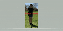 a person in a black shirt and blue shorts stands in a grassy field with bump barnes in red letters