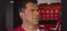 a race car is driving on a wet track with a heineken sign behind it