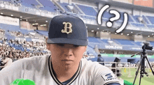a baseball player is wearing a blue hat with the letter b on it .