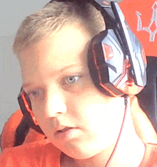 a young man wearing a pair of headphones with a red arrow on the wall behind him