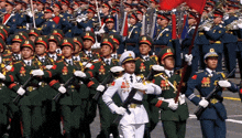 a man in a white uniform stands in front of a large military march