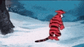 a cartoon tiger is walking through the snow .