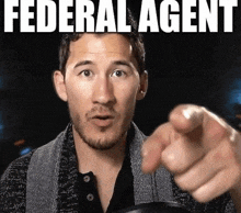 a man with a beard pointing at the camera with the words federal agent behind him