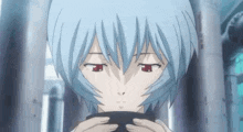 a close up of a person with blue hair holding a black object in their hands .