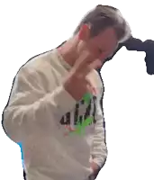 a man wearing a white sweater that says a.i.c.i. on it
