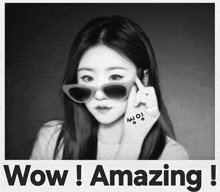 a black and white photo of a woman with sunglasses and the words wow amazing