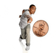 a man is pointing at a penny that says liberty 2010