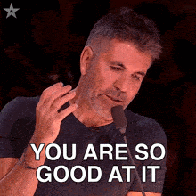 a man speaking into a microphone with the words you are so good at it above him