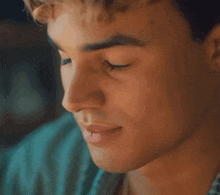 a close up of a man 's face with his eyes closed and his mouth open