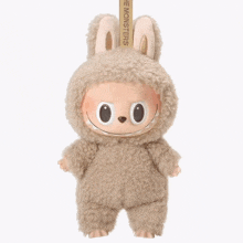 a stuffed animal with a man 's face on it has the word monsters on it