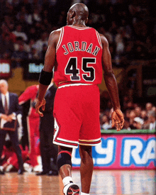 a basketball player with the number 45 on his back walks on the court