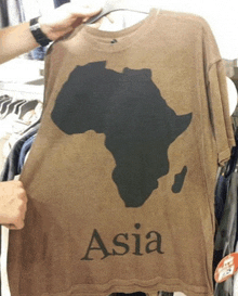 a brown t-shirt with a map of africa and the word asia on it