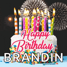 a birthday cake with candles and fireworks with the name brandin