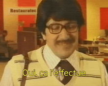 a man with glasses and a mustache says oui ca l' effetue