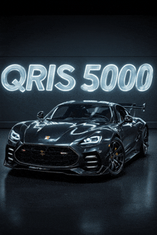 a black sports car with a neon sign that says qris 5000