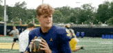a football player in a blue jersey with the number 3 on it