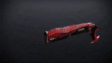a red and black weapon with a red handle on a dark background