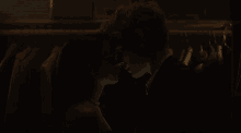 a man and a woman kiss in a dark room