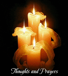 a picture of four lit candles with the words thoughts and prayers above them