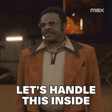a man says let 's handle this inside while wearing a brown jacket