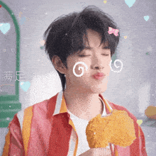 a young man eating a fried chicken wing with chinese writing on his face