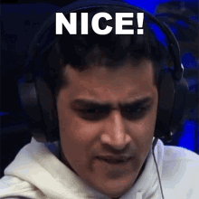 a man wearing headphones has the word nice written on his face .
