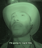 a man wearing a cowboy hat and ear buds says i 'm going to regret this