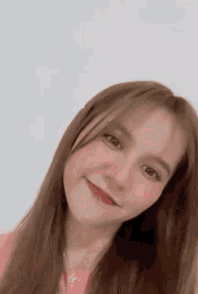 a close up of a woman 's face with long brown hair