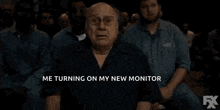 a man with a surprised look on his face is sitting in front of a crowd and says oh my god .