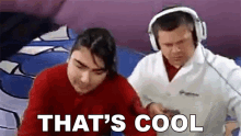 a man wearing headphones is standing next to a woman who is wearing a red shirt .