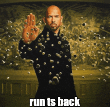 a man in a black suit is surrounded by bullets and the caption reads " run ts back "