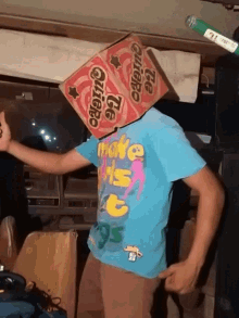 a person wearing a blue shirt with a box on their head that says te quiero