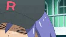 a cartoon character wearing a black hat with the letter r on it