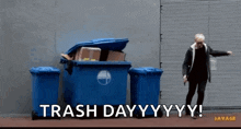 a man standing in front of a trash can that says trash day yy yy