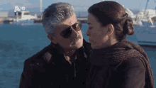 a man and woman are looking at each other with a hd logo in the background