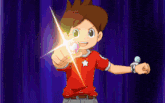 a boy in a red shirt with a white star on it is pointing at something