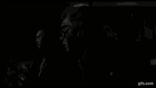 three men are standing next to each other in a black and white photo .