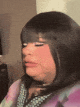 a close up of a woman 's face with a wig