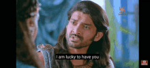 a man with long hair and a beard is saying i am lucky to have you .