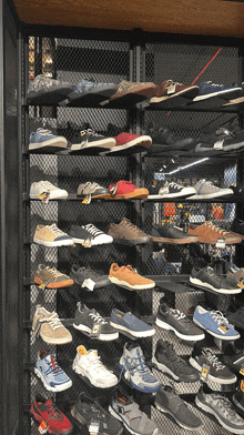 a display of shoes in a store with a yellow tag that says ' salomon ' on it