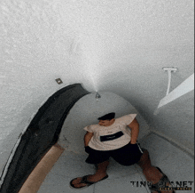 a tiny planet global photo of a person sitting in a room