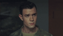 a man in a military uniform looks to the side